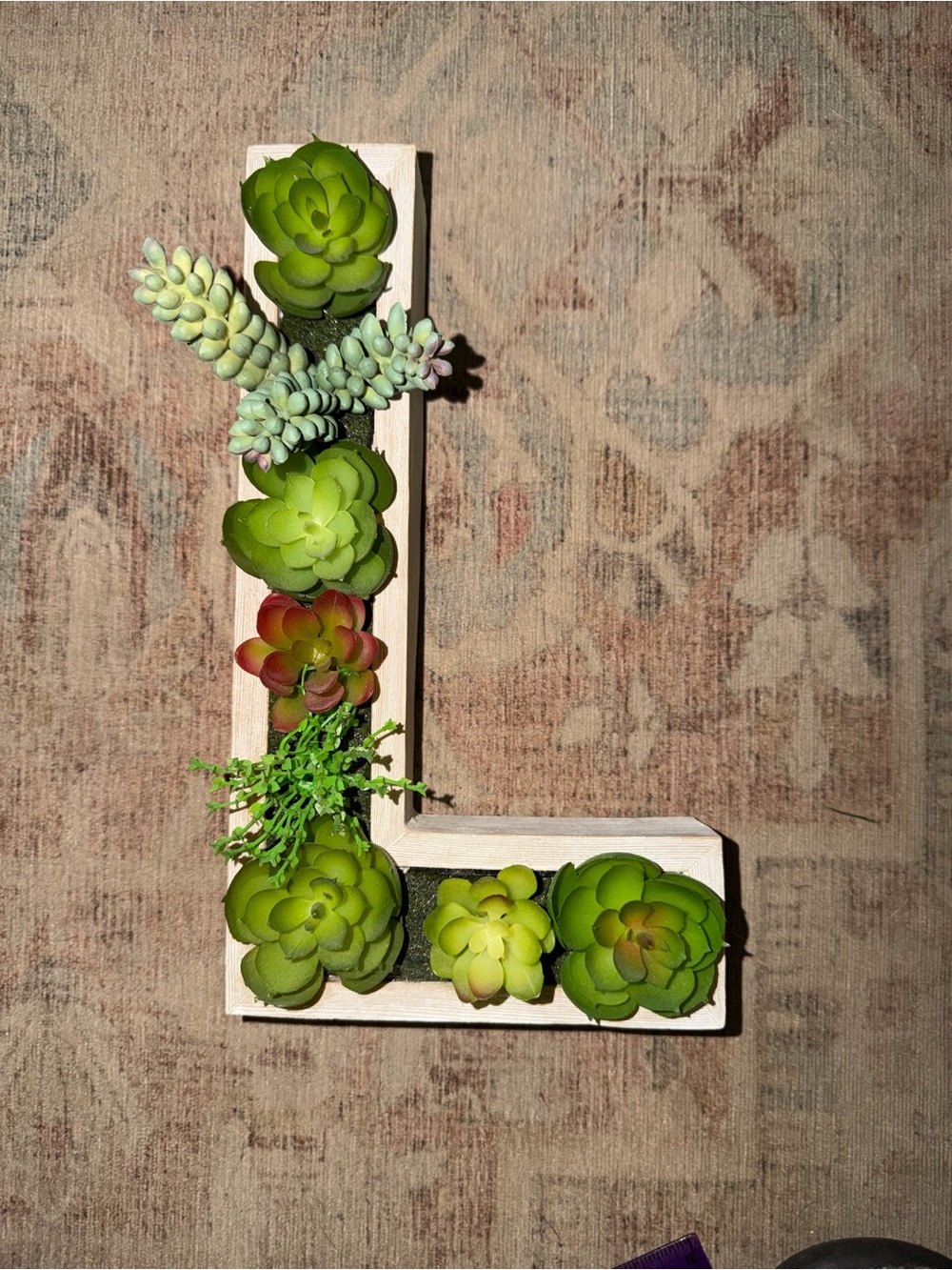 Green L-Shaped Wall Planter with Green Succulent Accents.